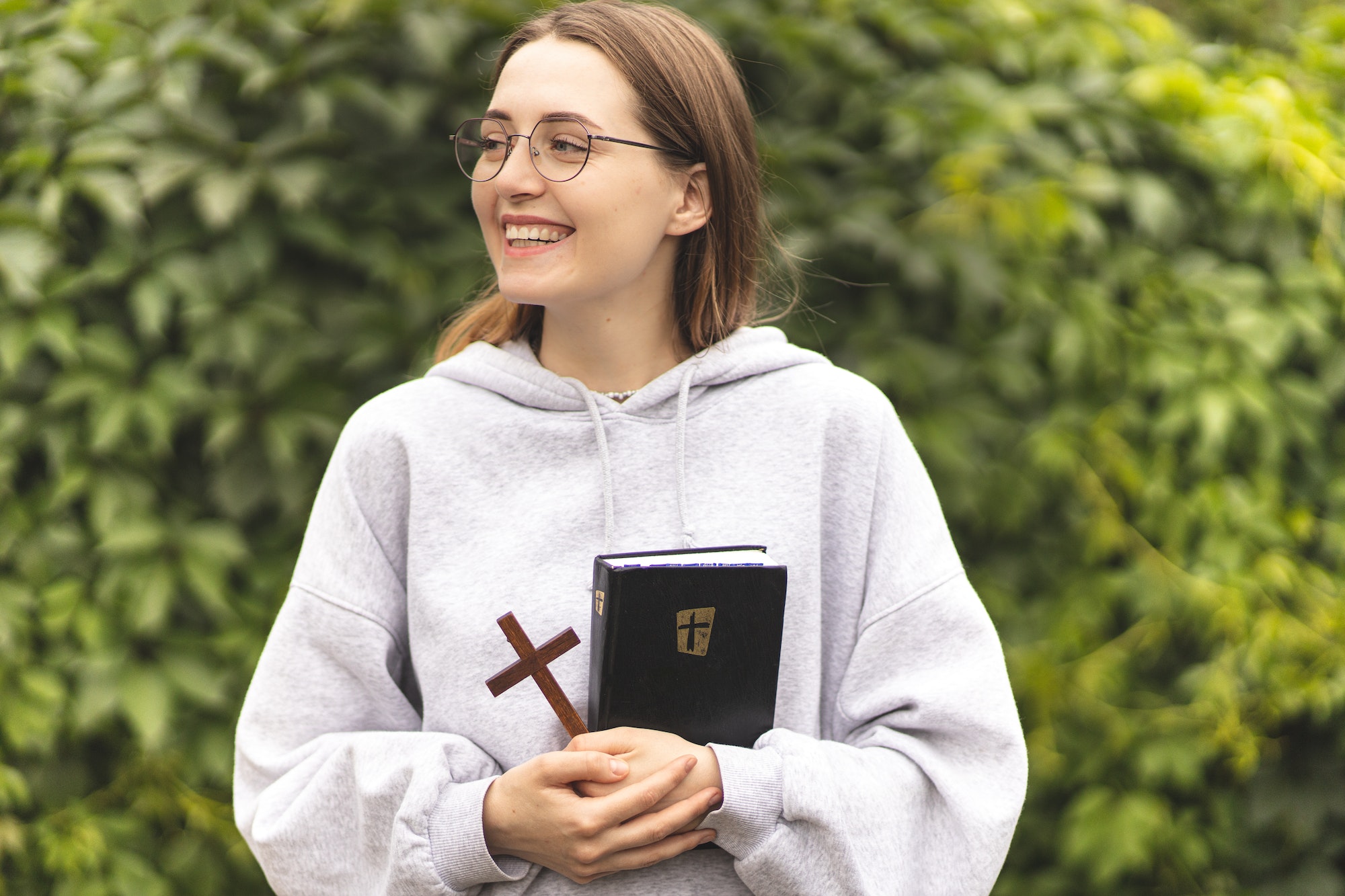 The girl reading the Bible and prays. Prayer. Faith and religion. Believing girl praying. Bible.